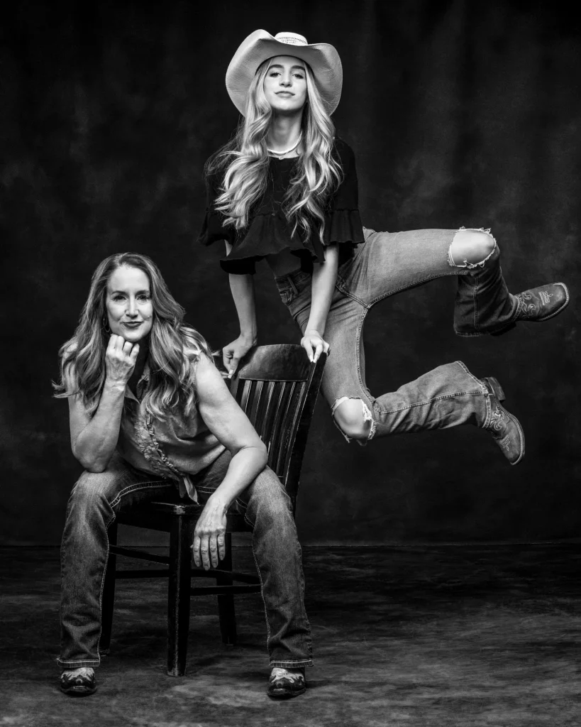 Mother and daughter wearing casual jeans, cowboy boots and cowboy hat for their family photo session at Richard Hill Studio