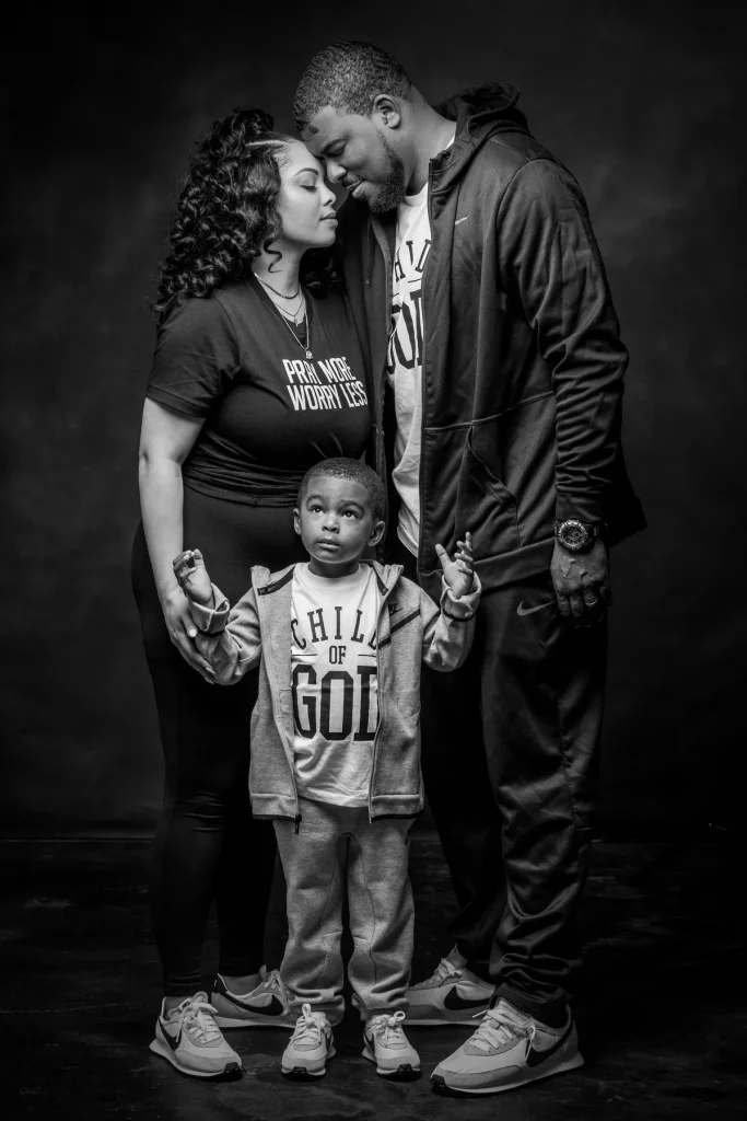 Mother, father and son embrace at their family session at Richard Hill Family portrait studio in Dallas Texas