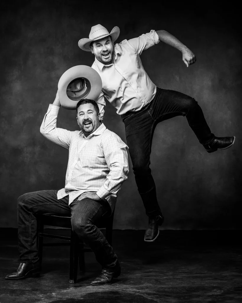 Two men wearing cowboy hats during family portrait session at Richard Hill Studio in Dallas