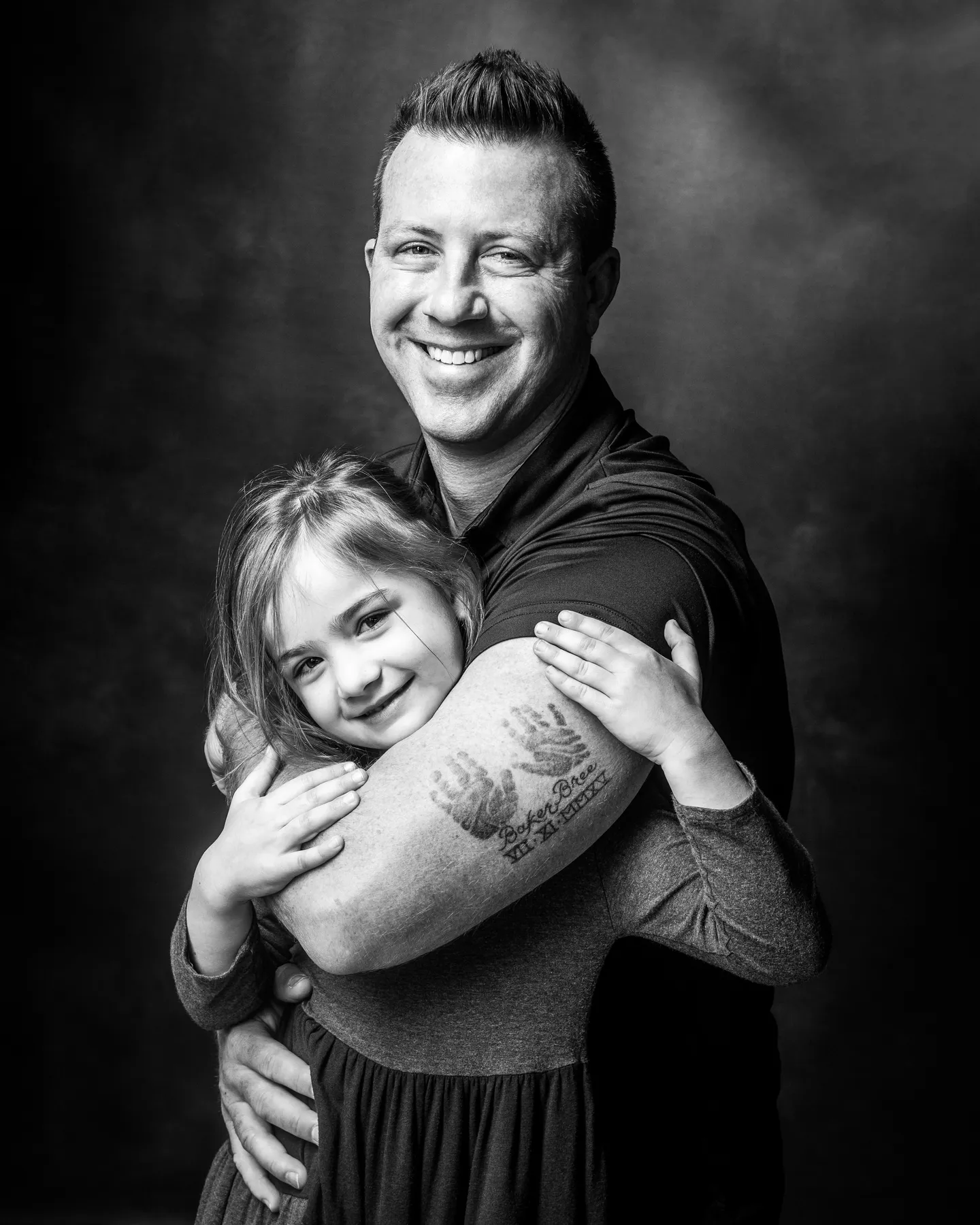 Happy North Texas father and daughter laughing together during studio portrait session at Richard Hill Studio