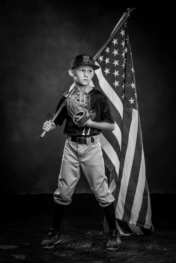 Young athlete with american flag and baseball mitt. ATHLETE & SPORTS PHOTOGRAPHER DALLAS TEXAS