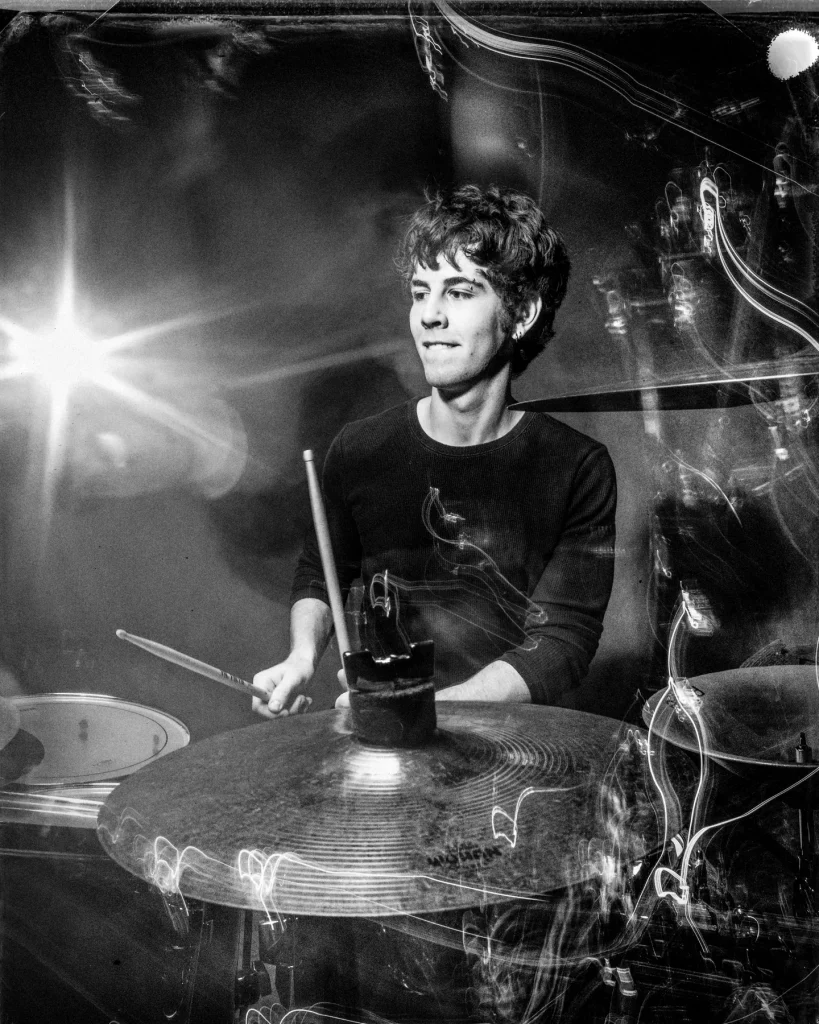 Young drummer with kit during his photosession at Richard Hill Studio